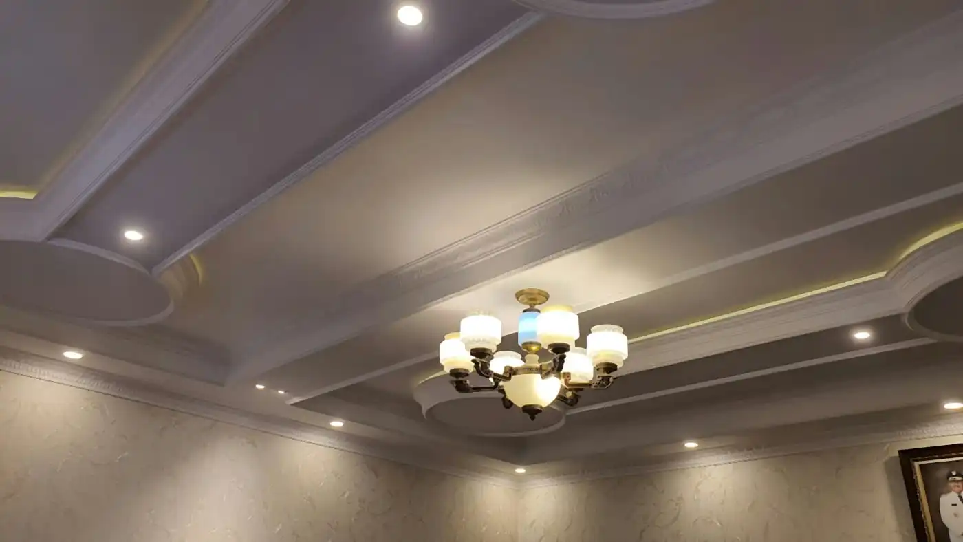 False ceiling with cove lighting, recessed spotlights and a chandelier