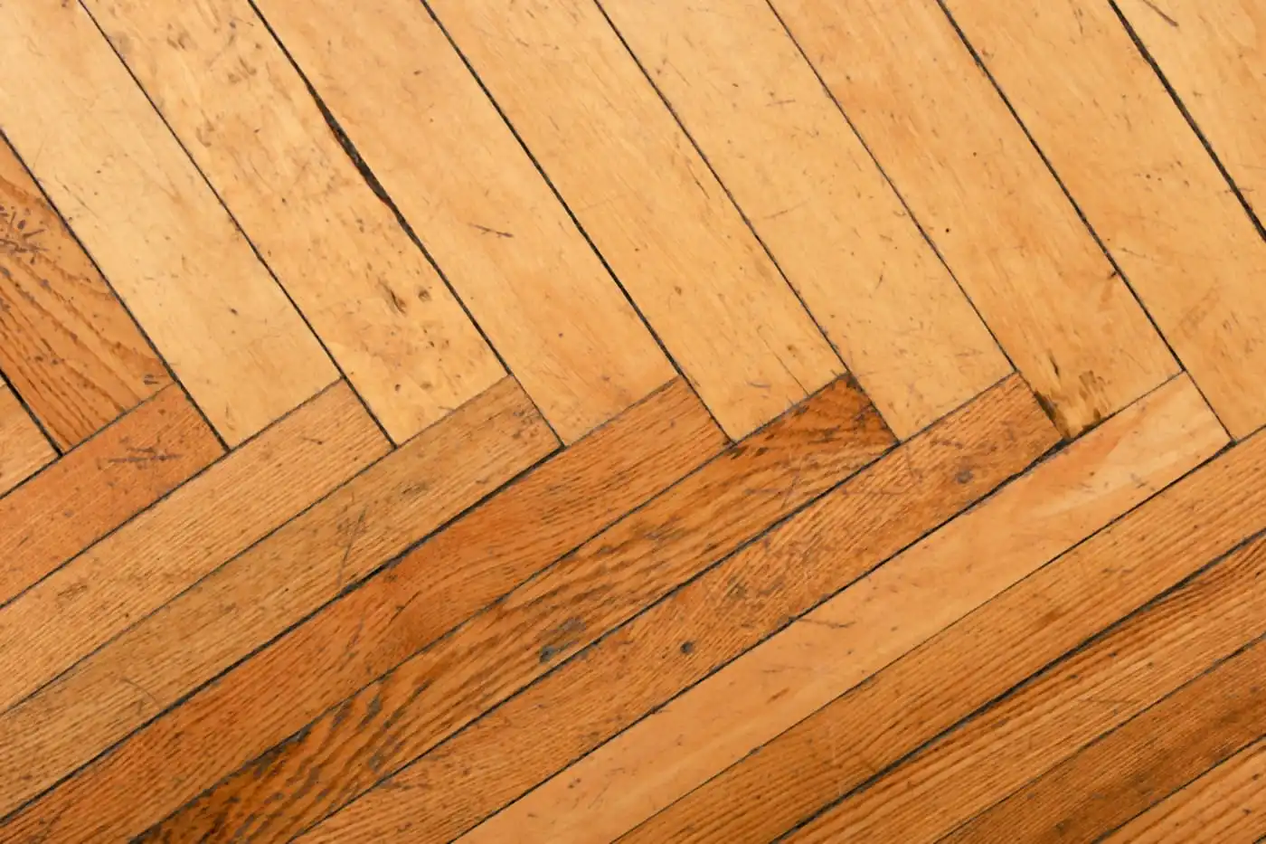 Herringbone wooden floor in warm oak tones